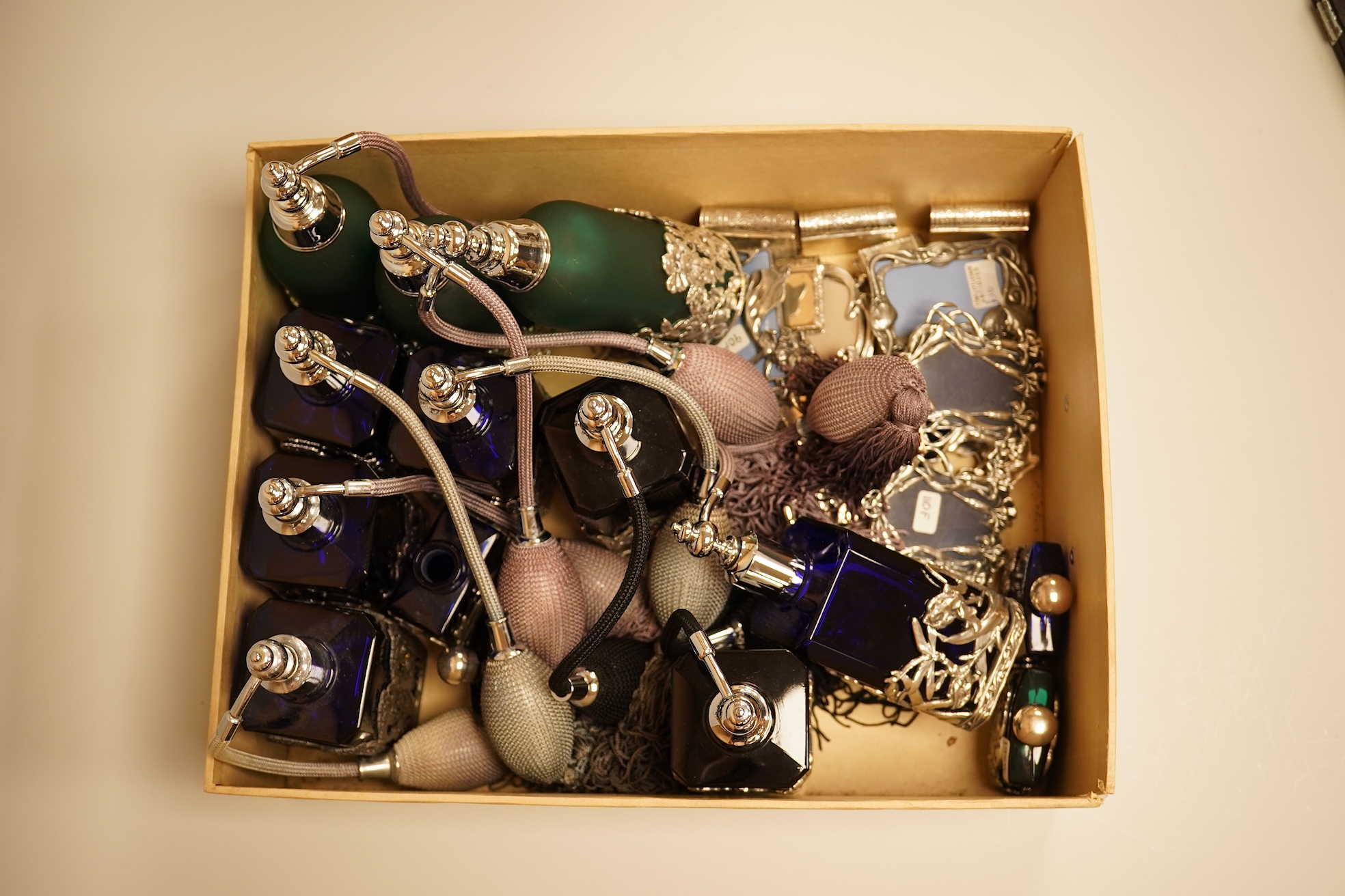 A collection of decorative glass and metal perfume bottles, miniature frames and pill boxes, green glass perfume bottle 15.5cm high.